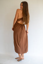 Load image into Gallery viewer, A woman modeling a brown backless wrap maxi dress, shown from the back against a plain white studio background.
